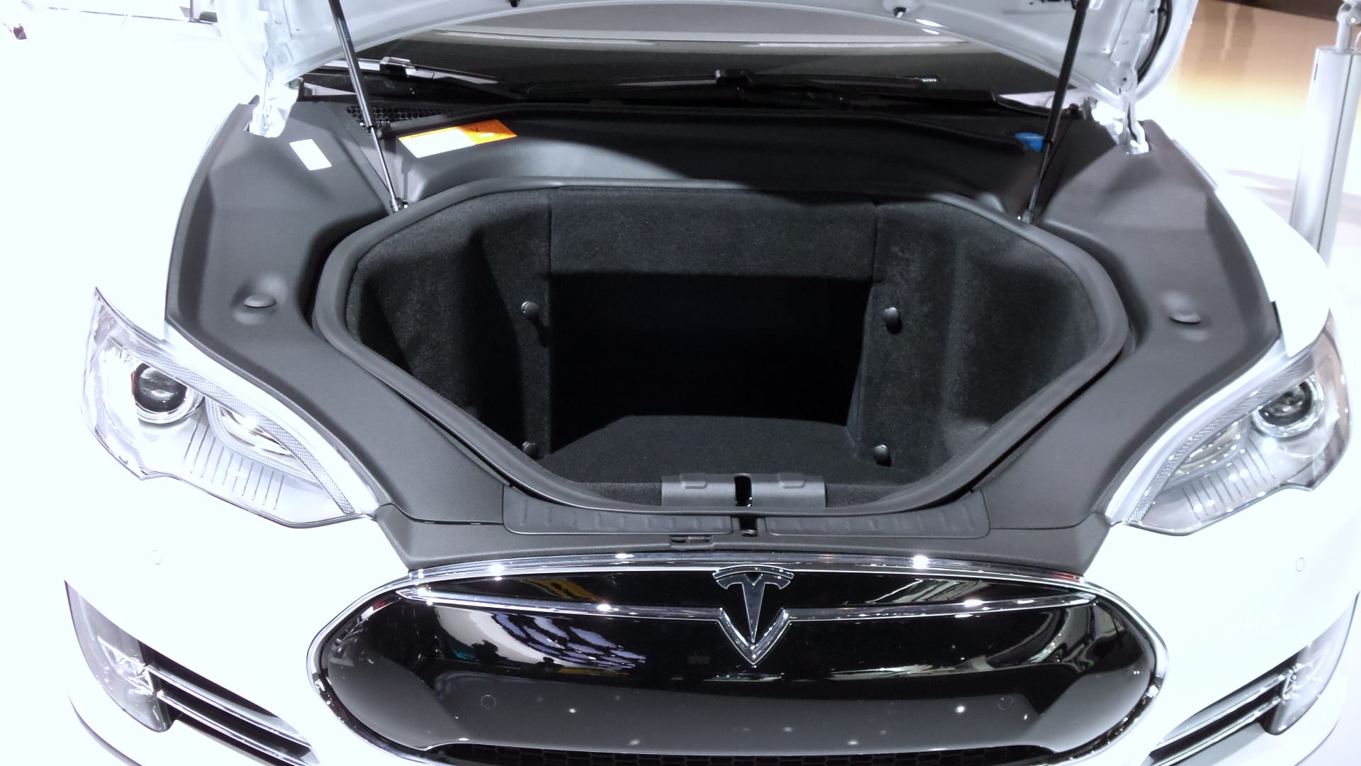 The front trunk of the white Tesla Model S.