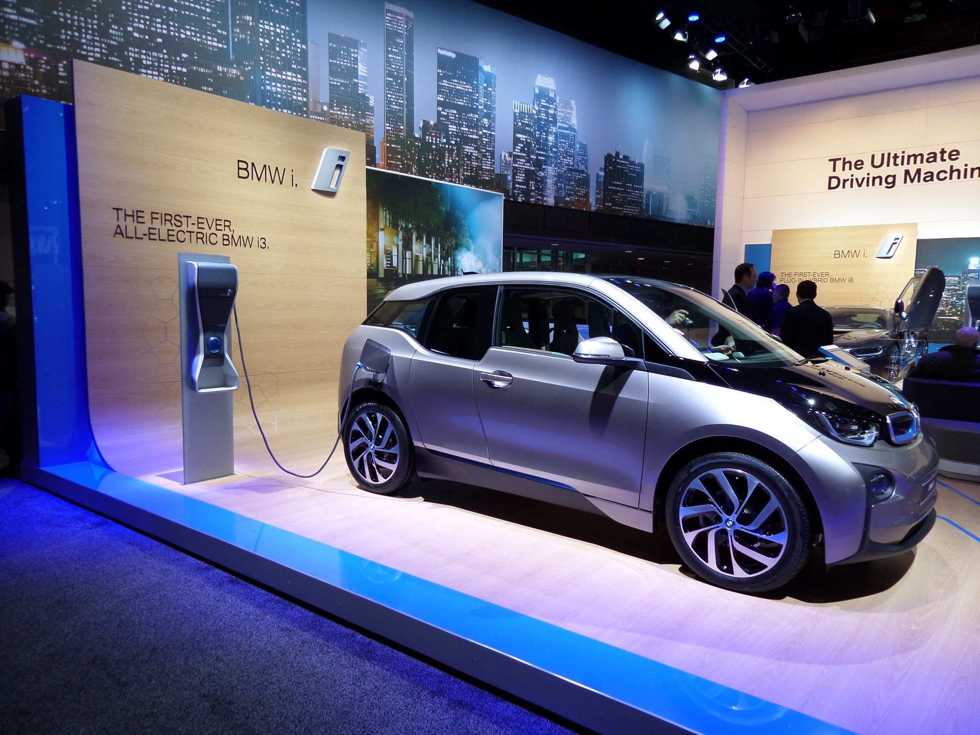 A two-door, black and silver BMW i3 electric car. Side view.
