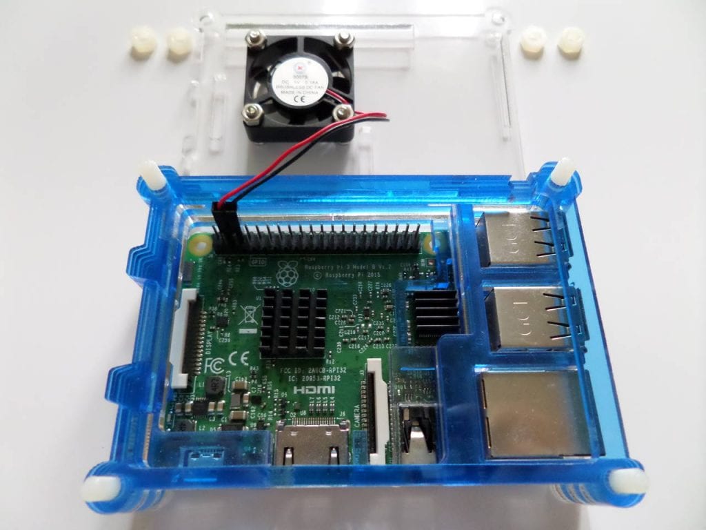 A Raspberry Pi in a case with a heatsink and fan